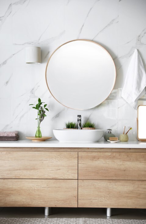 man brushing teeth in mirror with Colgate toothbrush